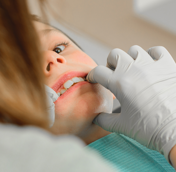 Dentist adjusting braces during treatment