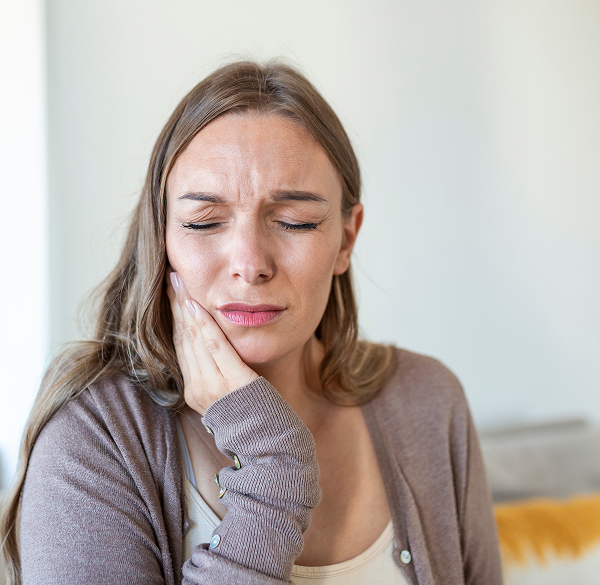 Woman experiencing tooth sensitivity