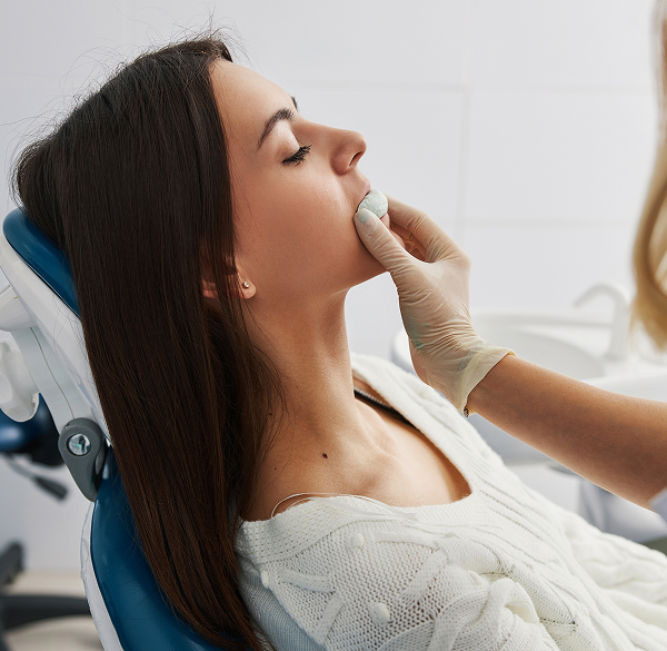 Woman with bleeding gum after baby tooth loss