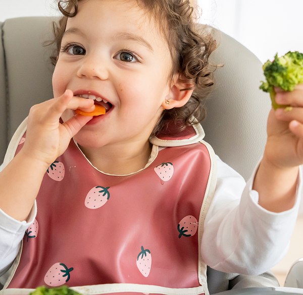 Toddler eating healthy vegetables