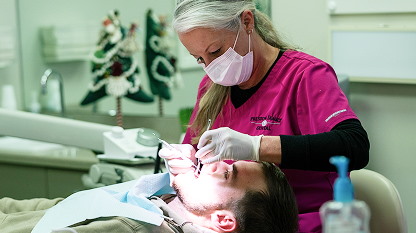 Dentist performing dental procedure
